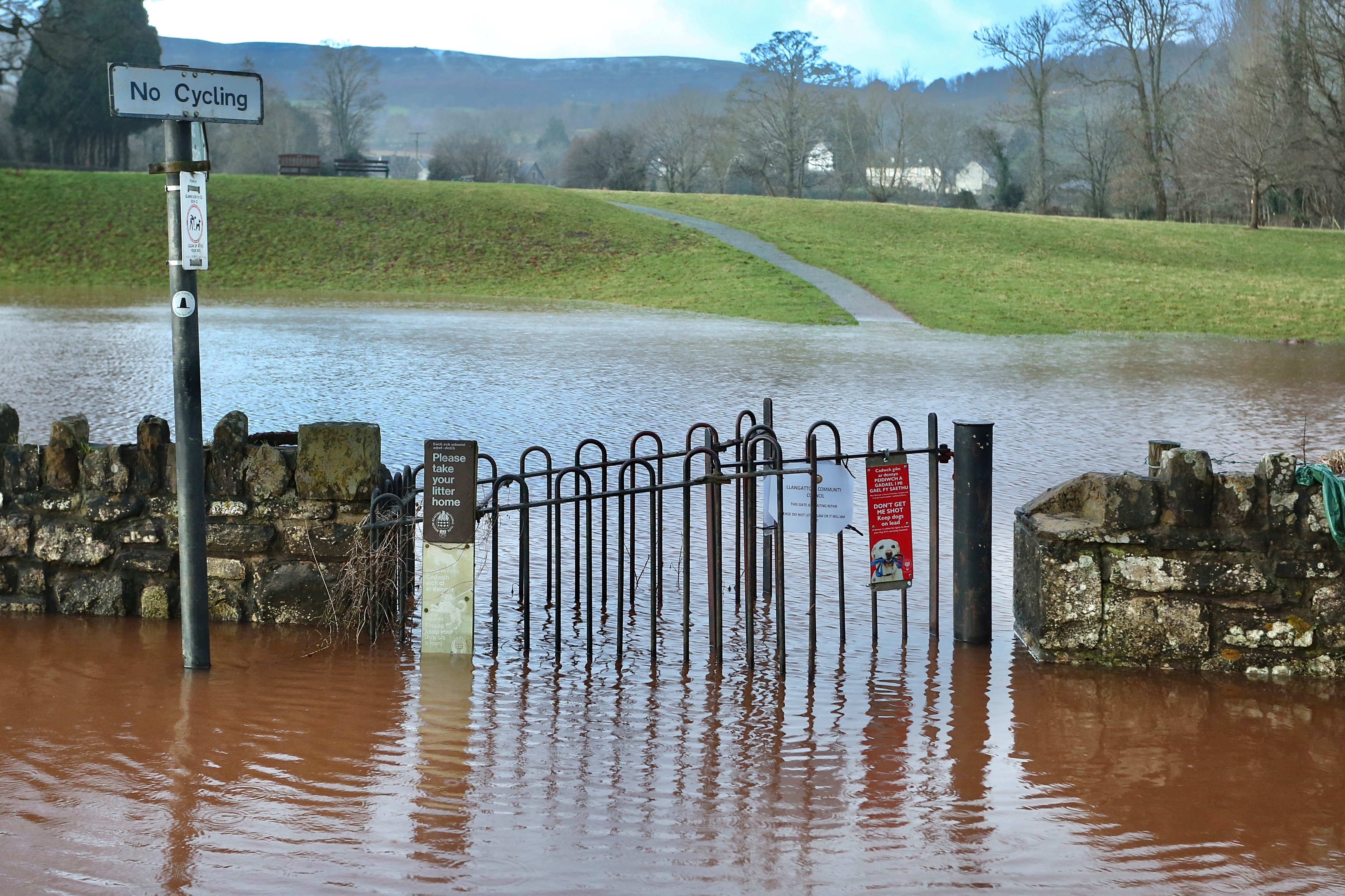 The Usk river bursts it banks at Crickhowell, in South Wales this morning