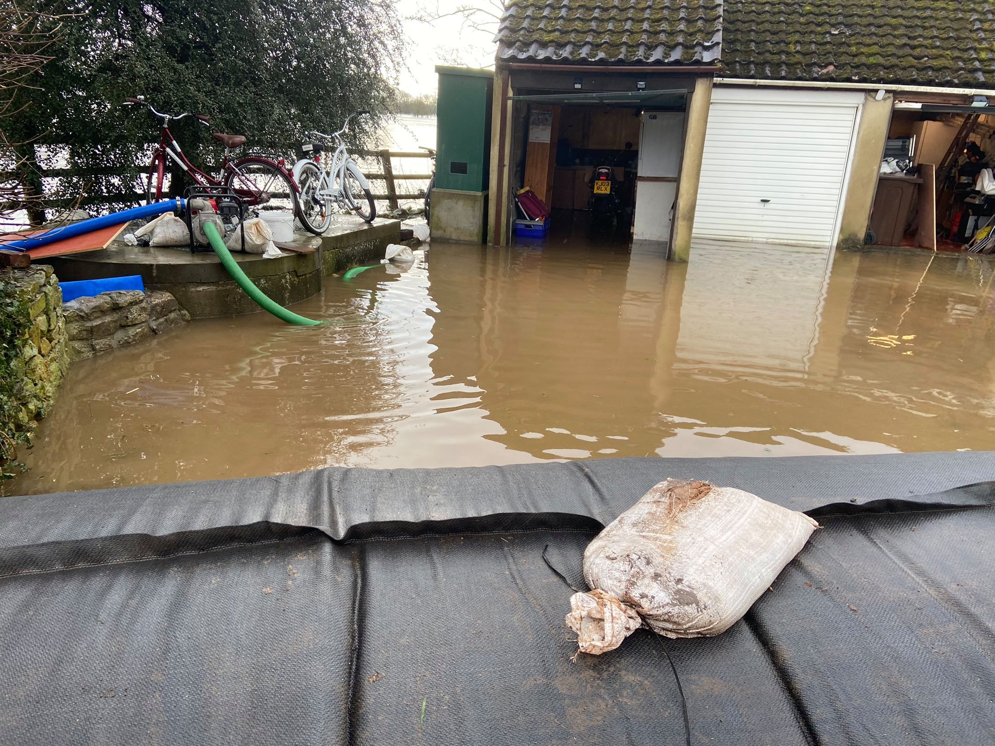 Crews from North Yorkshire Fire & Rescue Service use temporary flood barriers to protect properties from high flood water at Kirby Wharf, nearr Tadcaster