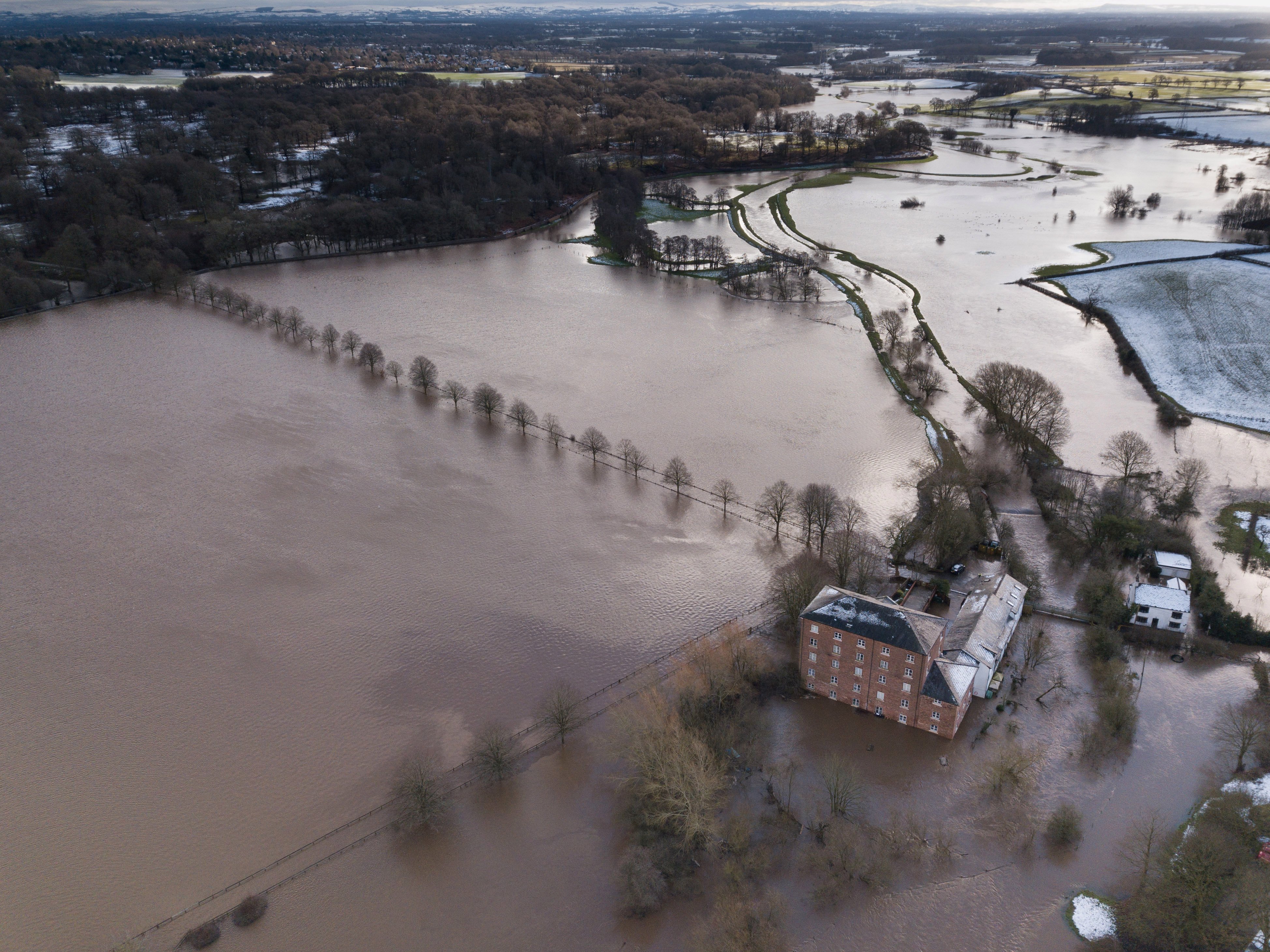 Homes surrounded by flood water in Little Bolligton, Cheshire as the River Bollin bursts its banks