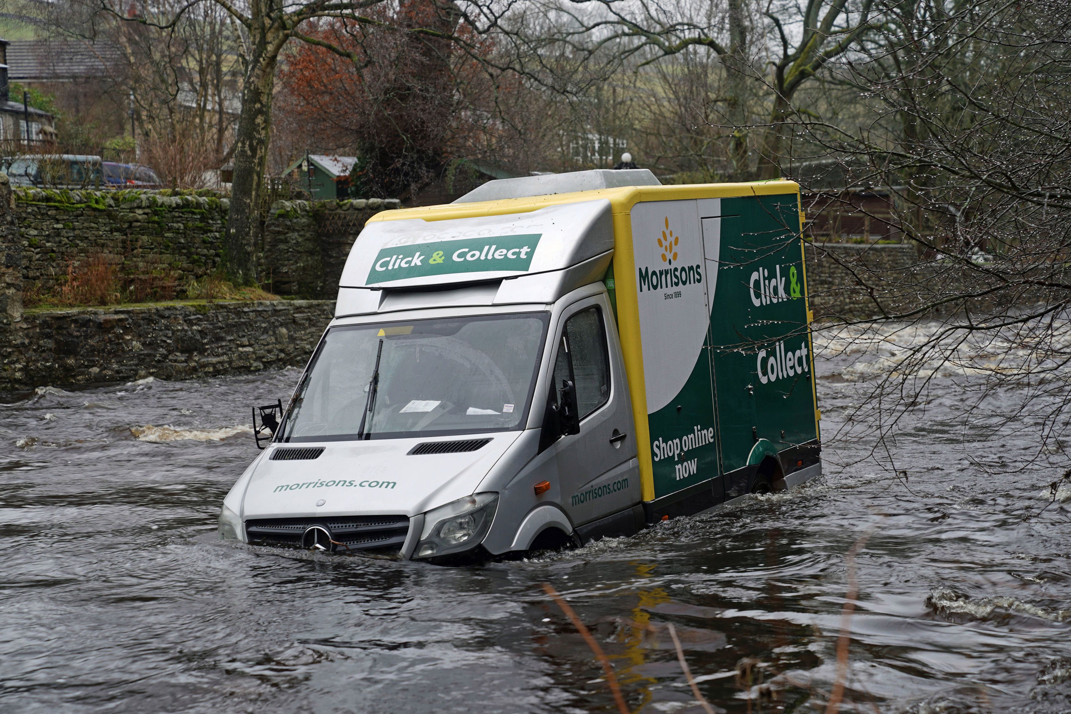 A Morrisons van remains stranded in floodwater in Durham after the delivery driver was rescued last night