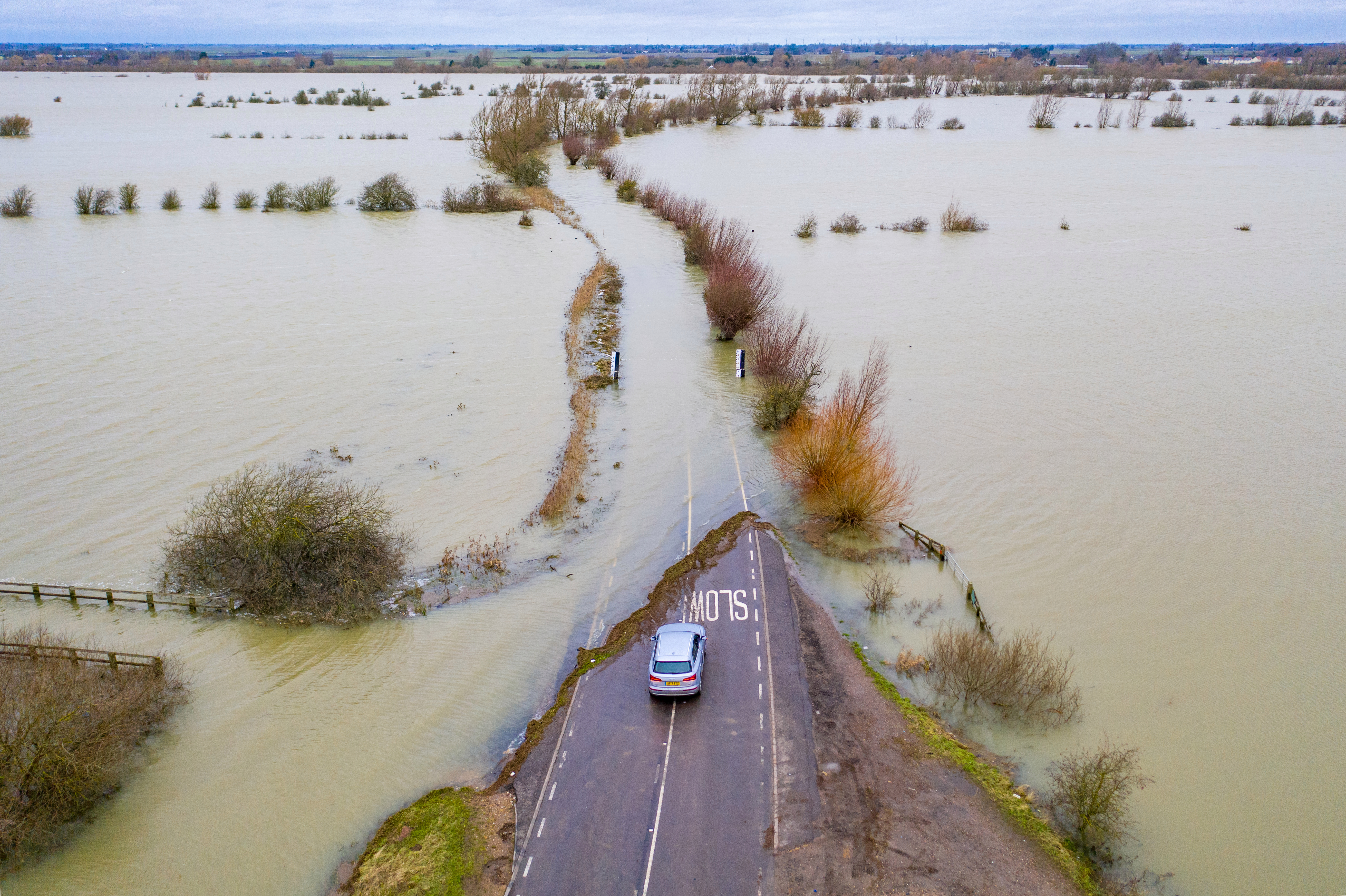 A car stops ahead of a road submerged in floodwaters on the Norfolk/Cambridgeshire border yesterday