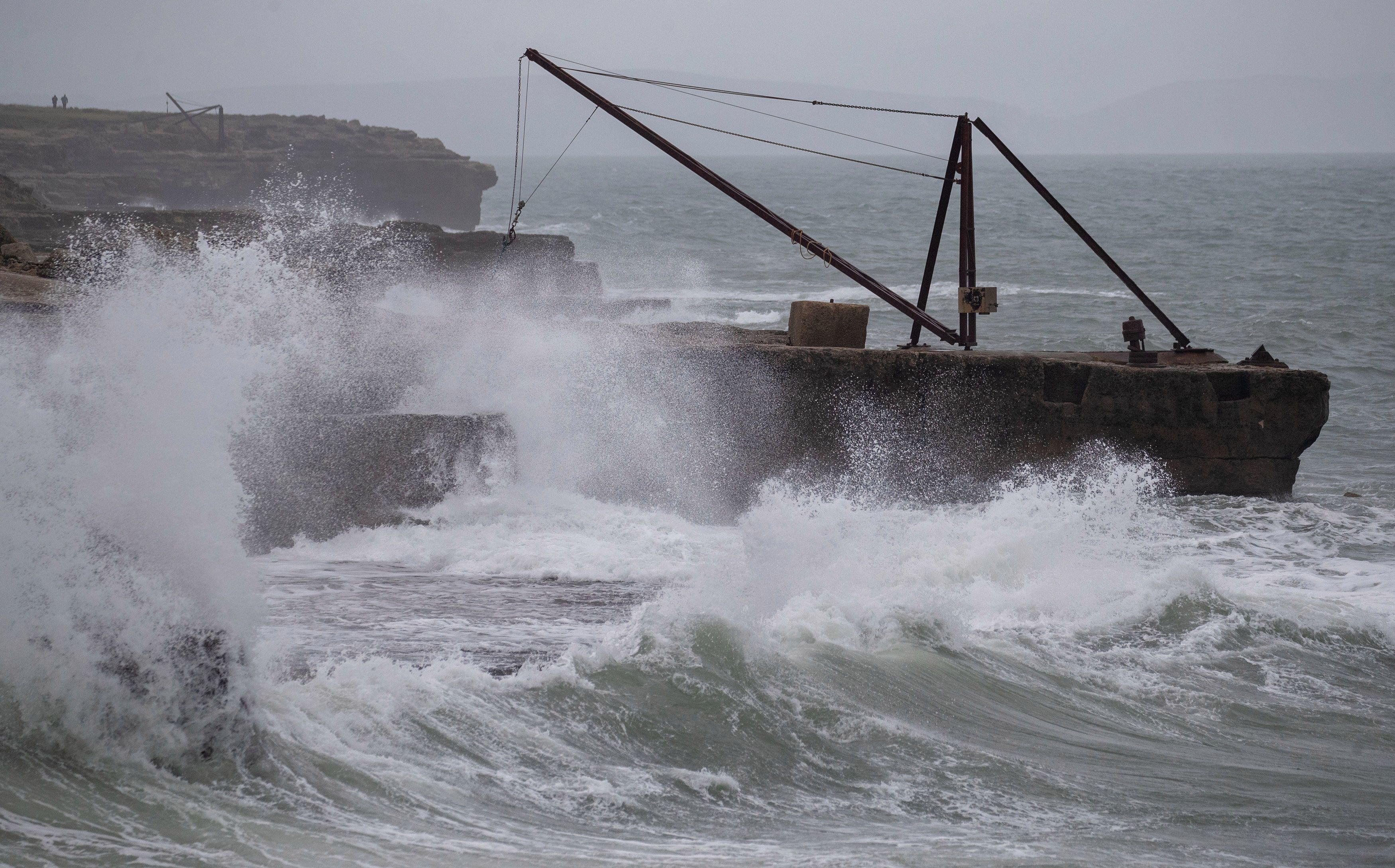 Waves crash against the shoreline at Portland Bill in Dorset