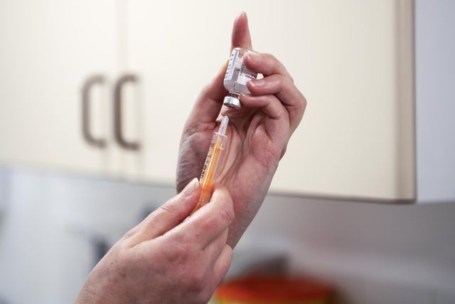 Advanced nurse practitioner Justine Williams prepares a dose of the AstraZeneca/Oxford Covid-19 vaccine at the Lochee Health Centre in Dundee.