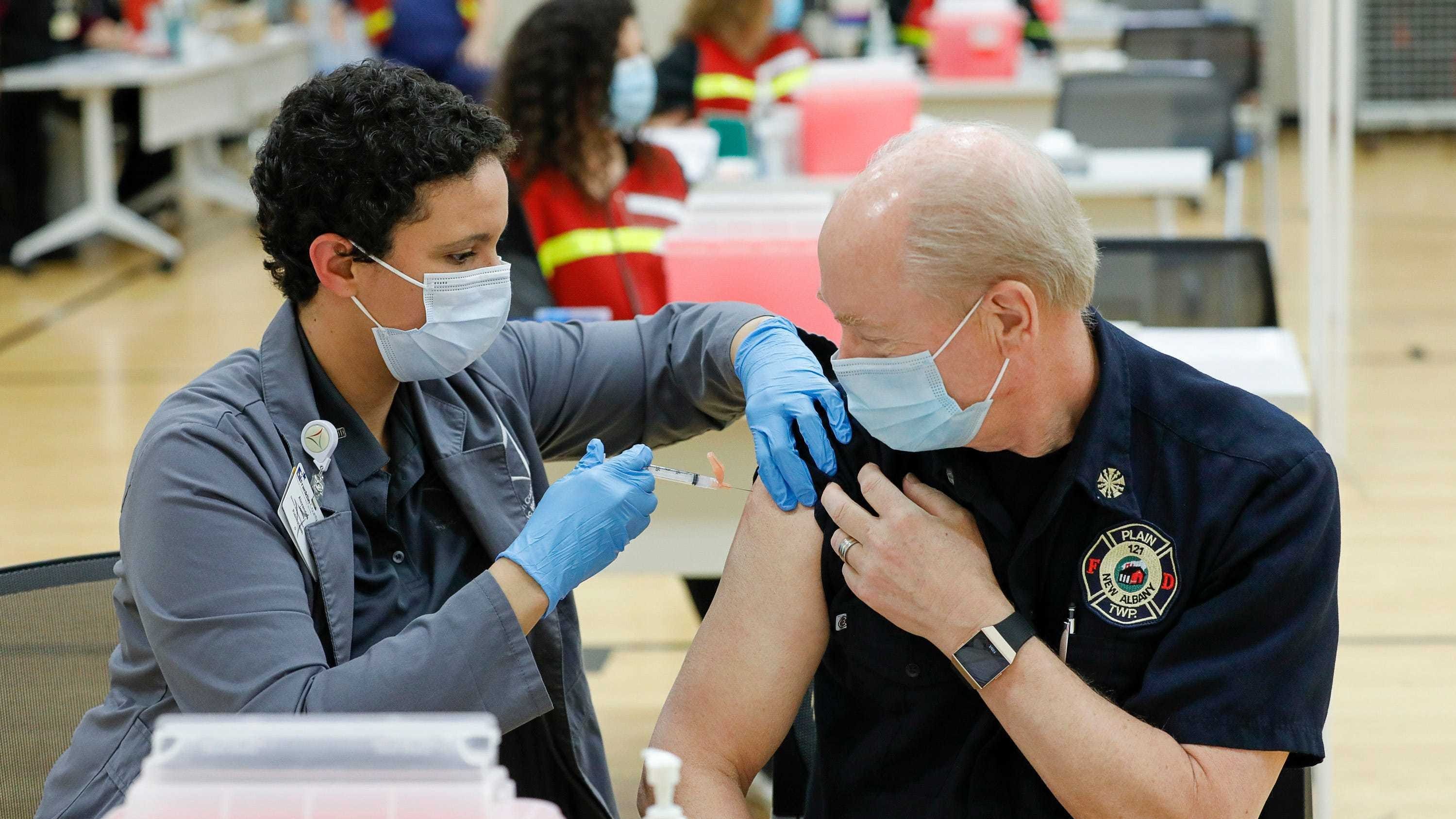 Franklin County assistant health commissioner Alexandria Jones gives a COVID-19 vaccine to New Albany Plain Township fire chief Jack Rupp on Monday, Dec. 28, 2020. Franklin County Public Health received 4300 doses of the Moderna vaccine and can administer up to 540 per day to those in the first phase of vaccine distribution, which includes EMS responders.