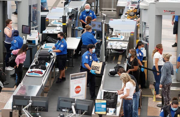 Transportation Security Administration agents processing passengers at Denver International Airport in June.