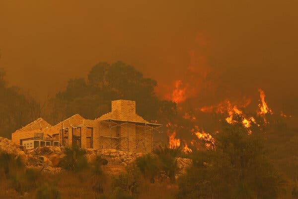 Flames near a property under construction in Perth, Australia, on Tuesday.