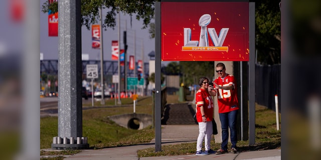 In this Feb. 4, 2021, file photo, Kansas City Chiefs fans take a selfie outside of Raymond James Stadium ahead of Super Bowl 55 in Tampa, Fla. (AP Photo/Charlie Riedel, File)