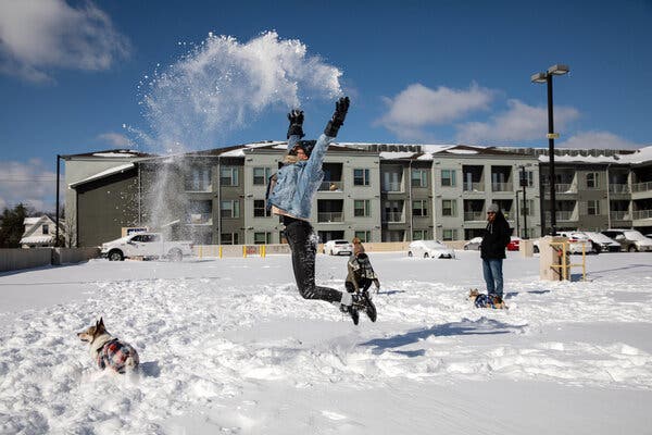 Mackenzie Mitchell plays in the snow outside her apartment complex in Austin, Texas, on Monday after the storm passed.