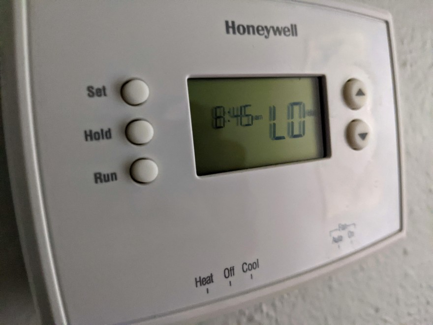 A photo of a thermostat that no longer shows temps. Instead, because of plummeting temperatures, it only reads 'lo'.