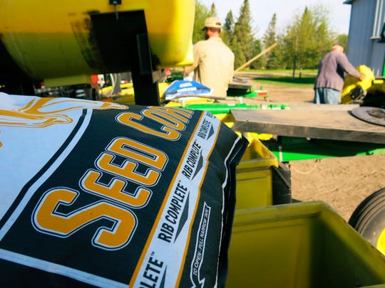 In this 2015 photo, a bag of corn seed sits ready for spring planting near Moorhead, Minn. Farmers Business Network compares seed prices from different companies to help farmers save money.