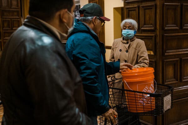 Residents in the lobby of the Granada Homes, a low-income apartment complex for the elderly in San Antonio, collected buckets of water to bring back to their bathrooms in order to flush their toilets.