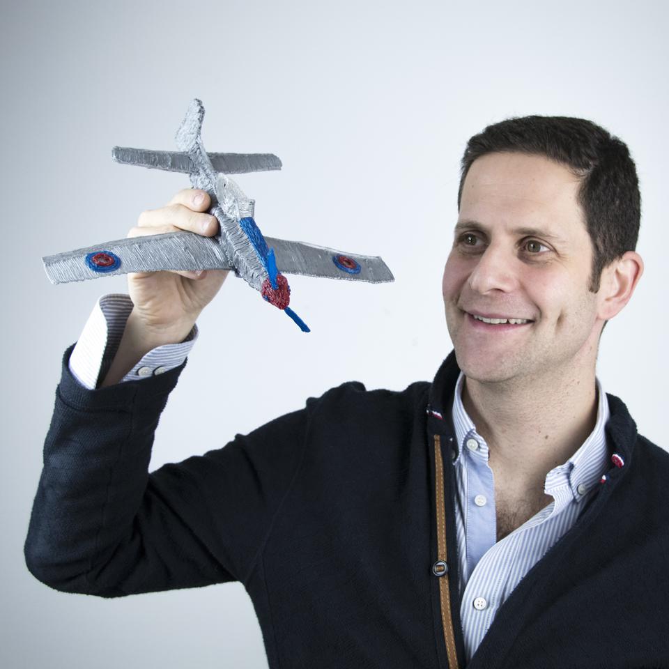 3Doodler Co-Founder and CEO Daniel Cowen holds a plane made with a 3D pen.