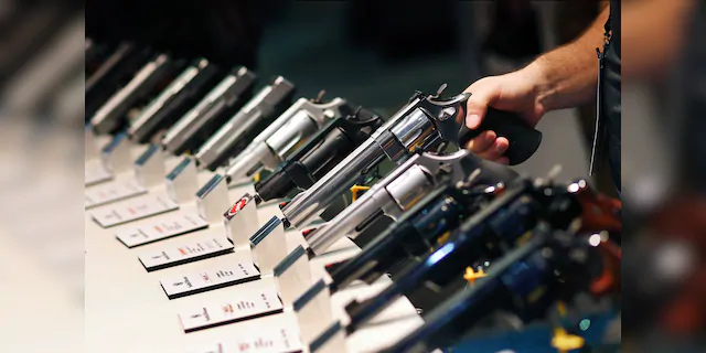 Handguns are displayed at the Smith &amp; Wesson booth at the Shooting, Hunting and Outdoor Trade Show in Las Vegas. (AP Photo/John Locher, File)