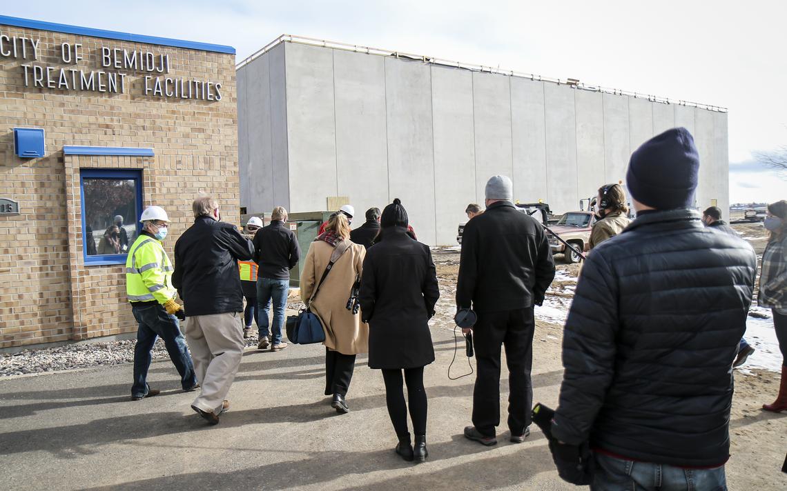 A group walks toward the new Bemidji water treatment plant on Oct. 29, 2020 during a tour of the facility, which is located near the Bemidji Regional Airport. (Annalise Braught / Bemidji Pioneer)