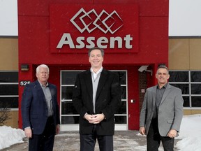 OTTAWA - Feb 19, 2021 - Andrew Waitman, CEO, (centre) Dave Curley, chief revenue officer, (left) and Marty Labelle, chief product officer (right) pose for a photo in front of Assent Compliance in Ottawa Friday. Assent Compliance, a supply chain software company that is closing in on US$1 billion in valuation, making it potentially Ottawa's next software star.  TONY CALDWELL, Postmedia.
