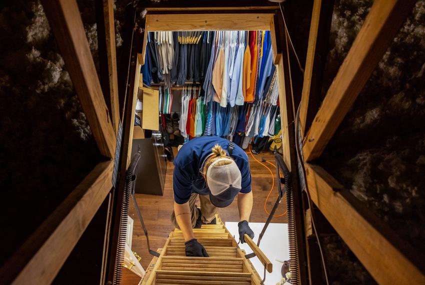 Zachary Shockency, a technician with Radiant Plumbing, looks for a burst pipe that caused flooding during last week's winter…