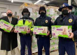 Captain Wall, Recruit Kasper, Trooper Iverson, and Trooper Kimura as they receive the pallets of diapers destined for distribution in rural Alaska.