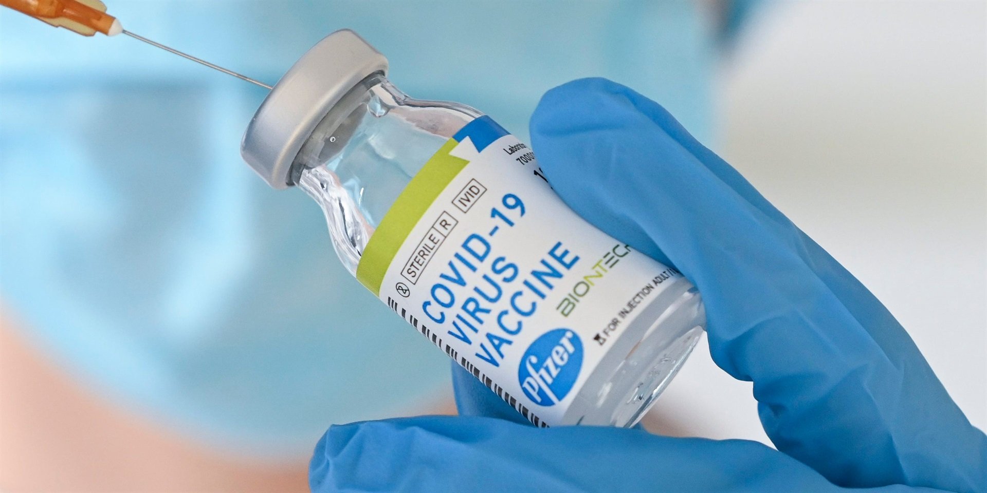 A doctor holding a vial of Pfizer's COVID-19 vaccine.