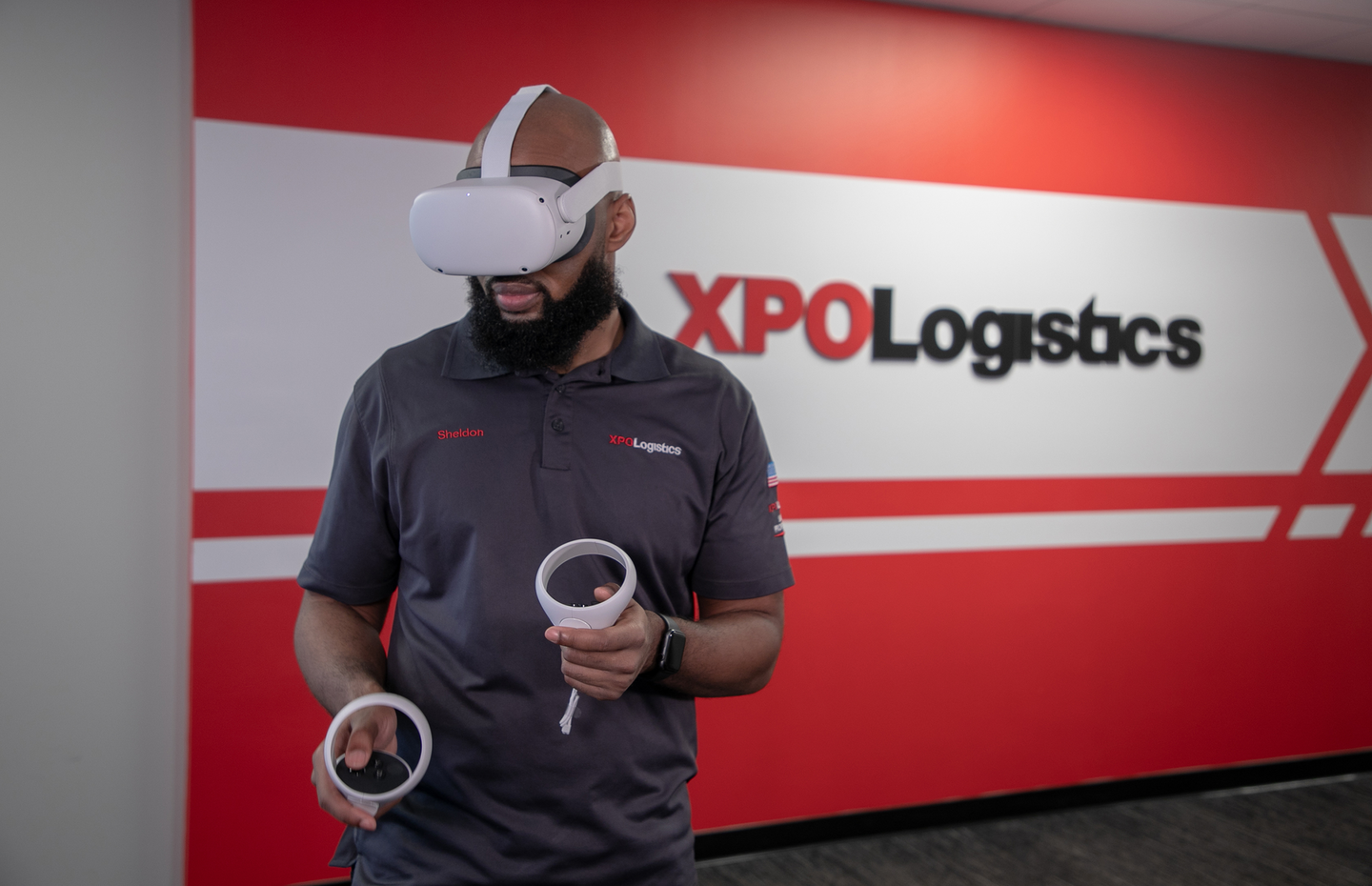 XPO's cross-docking platform integrates XPO software with Oculus for Business headsets. The user navigates the virtual environment with two handheld controllers.