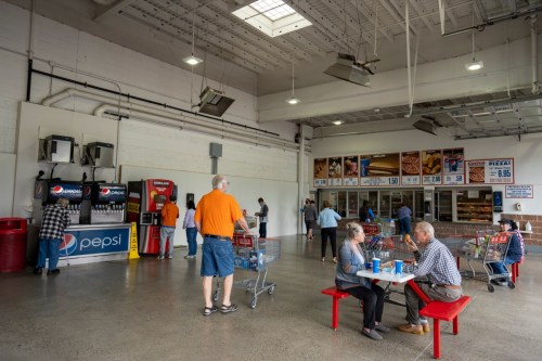 Clackamas, OR, USA - Jun 8, 2021: Shoppers enjoy their lunch in the distanced seating area at the Costco Store food court, as COVID cases continue to drop in Oregon.