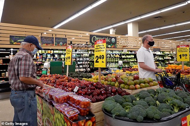 As grocery sales grow, customers buy produce at a Chicago supermarket in June.