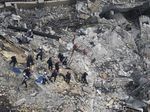 Rescue workers search in the rubble at the Champlain Towers South Condo, in Surfside, Fla, on June 26.