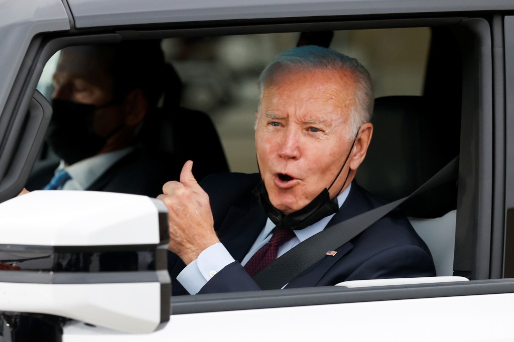 The president flashing a thumb up after the test drive.