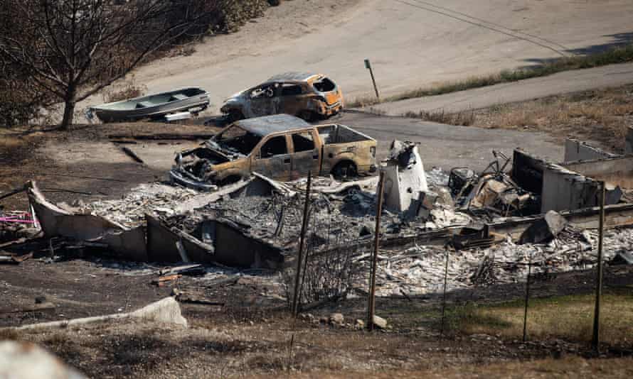 The remains of a home and vehicles destroyed by the White Rock Lake wildfire on the west side of Okanagan Lake, north of Kelowna, British Columbi
