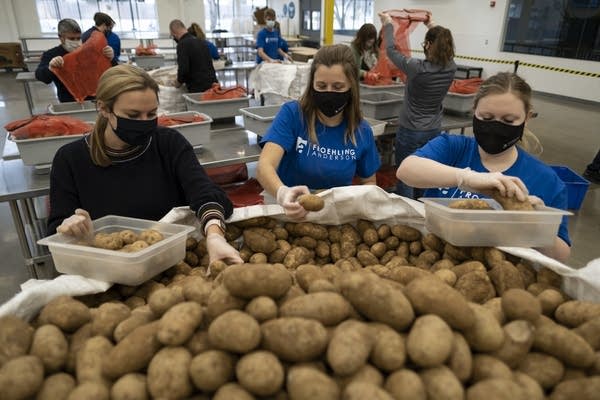 People work to pack food at a food shelf