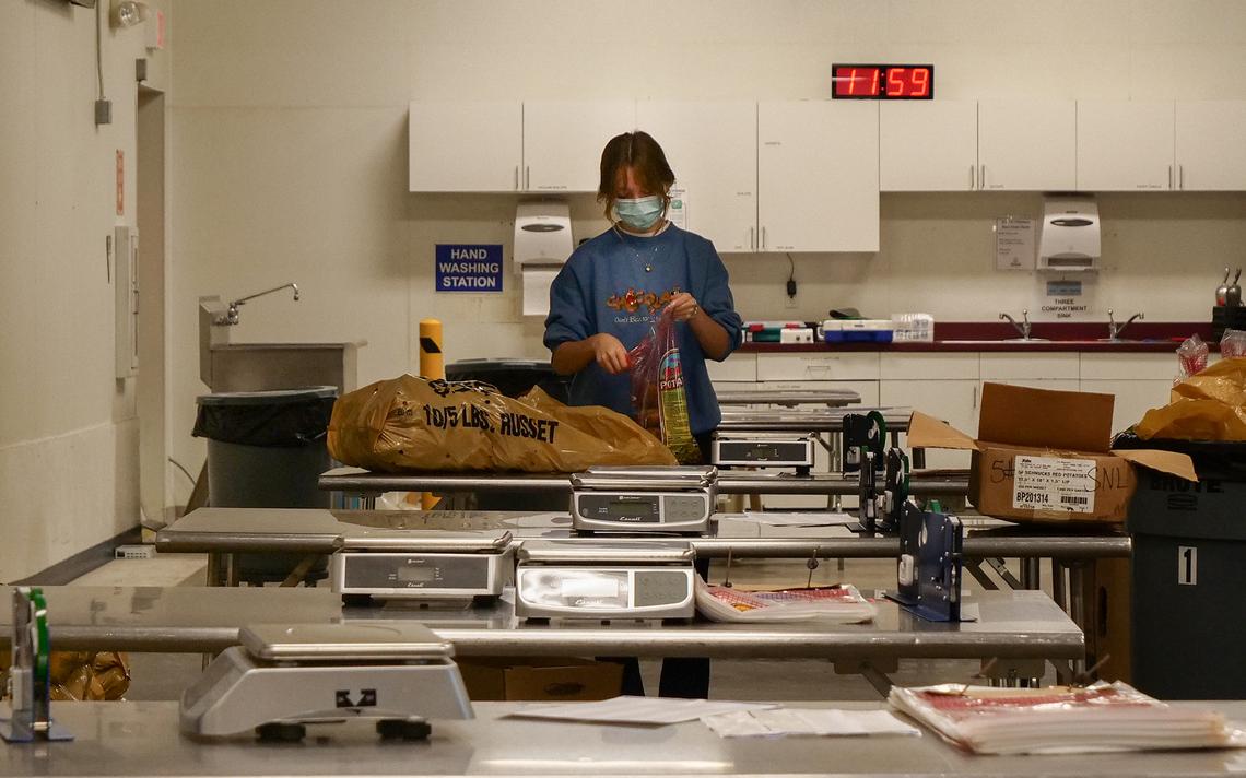 Isabel Burggraff volunteers at the Great Plains Food Bank in Fargo about twice a week. On Wednesday, Nov. 17, 2021, she was bagging potatoes.
Chris Flynn / The Forum