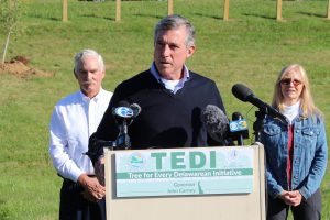 Governor Carney speaks behind a podium as he announces the Tree for Every Delawarean Initiative