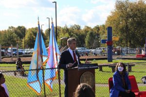 Governor Carney stands behind a podium outside at Delaware State University