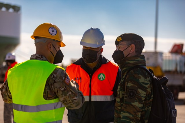 From left to right: U.S. Army 627th Movement Control Team Commander Capt. Eddie Quintero,  director of Transportation Corps, Eastern Mediterranean (Greece) Detachment Mr. Andre Cameron and Hellenic Army Port Operations Officer In Charge Lt. Col. Vasilios Yaglis discuss the movement of U.S. Army equipment from the vessel ARC Independence at the port of Alexandroupoli, Greece, Nov. 30, 2021. The 21st Theater Sustainment Command is U.S. Army Europe and Africa&#39;s lead organization for all sustainment activities, including logistics support, transportation, combat sustainment, human resources, finance, contracting and all other areas in the field of sustainment. 