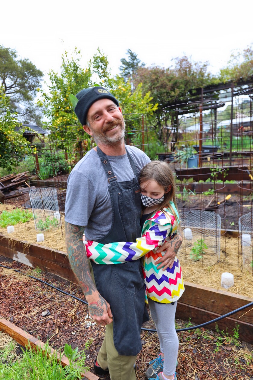 Brad Briske and his daughter in the garden at Home.