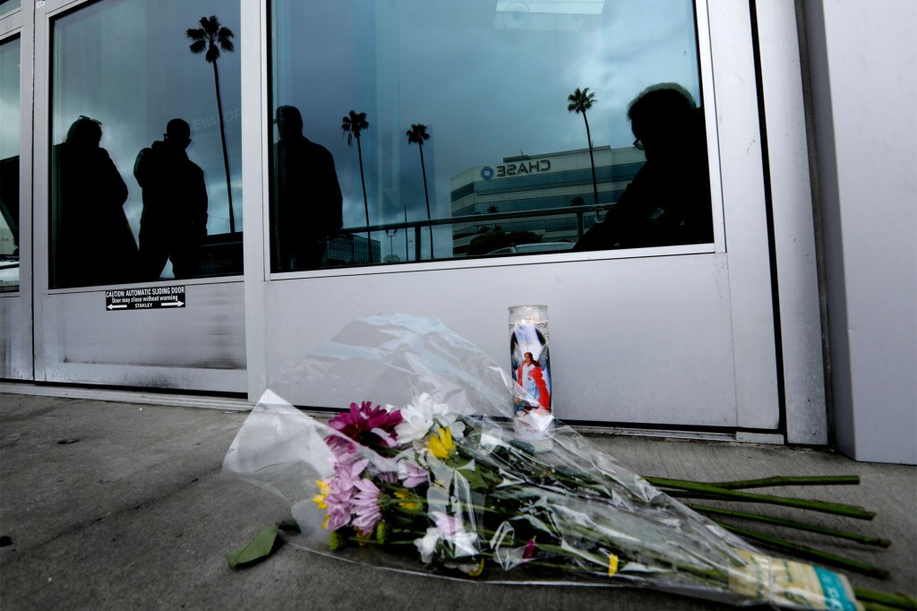 Flowers left outside of the store in memory of Orellana-Peralta.
