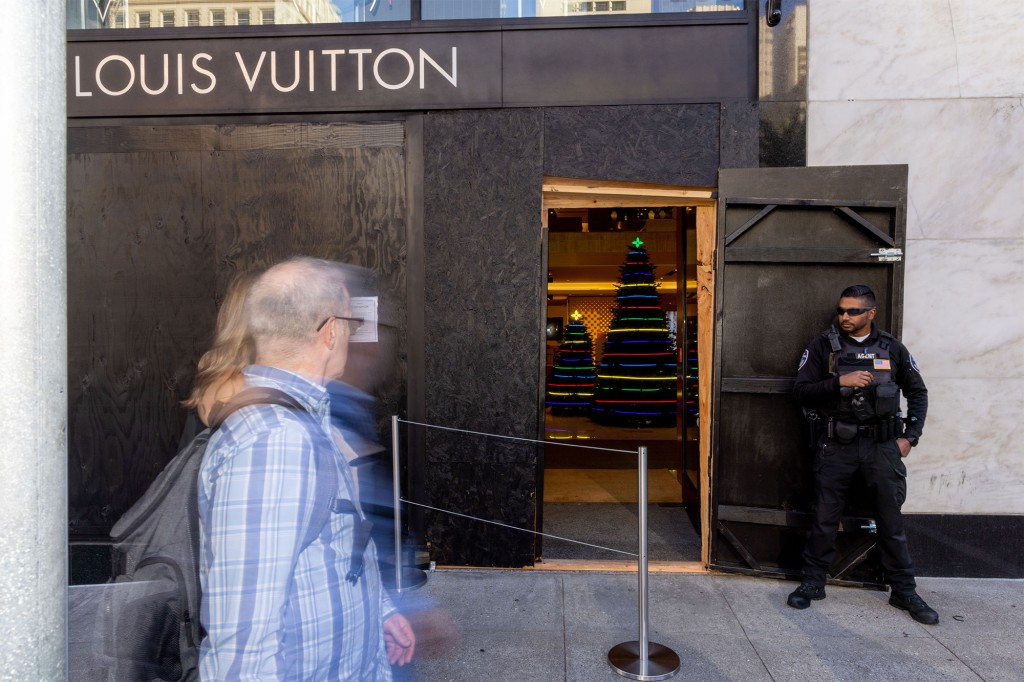 A security guard at a boarded up Louis Vuitton store that was looted in San Francisco.