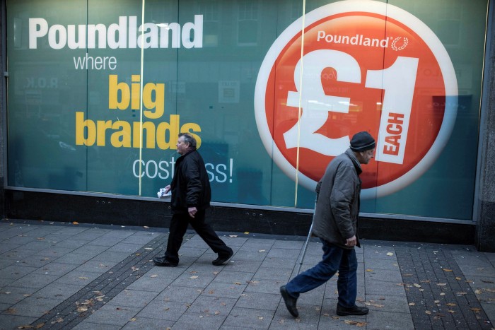 Members of the public walk passed a Poundland store in Nottingham, UK