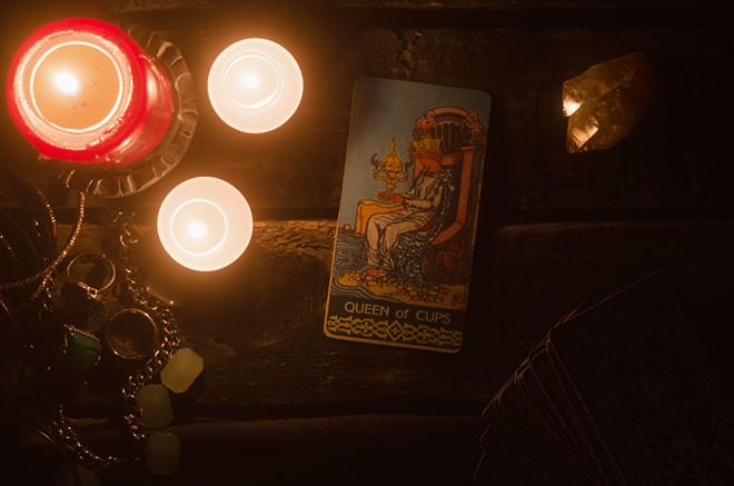 The Cups are also the suit of water, and the Queen of Cups has her throne on a beach. - ADOBE