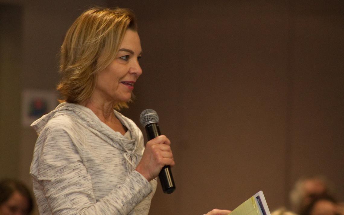 Dr. Debora Dragseth, professor of business administration at Dickinson State University, asks a question at an open forum. (Kayla Henson / The Dickinson Press)