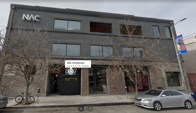 Street scene outside a modern-looking brick office building.