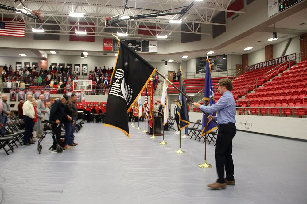 LYNN KUTTER ENTERPRISE-LEADER
There was silence as those attending a Veterans Day Assembly remembered soldiers who are missing in action or are prisoners of war. Farmington High student Mason Dooly presents the MIA/POW flag at the program.