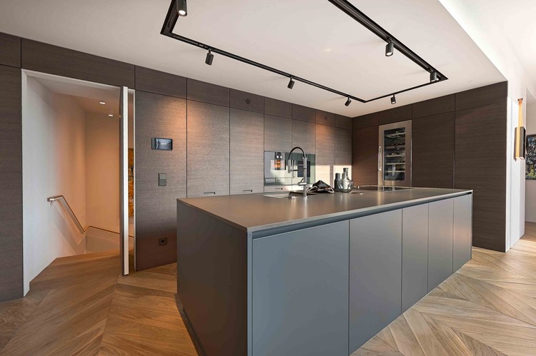 Hidden pantry or kitchen pivot door, clad with wood to submerge in the wall when closed / FADD Architects. Image Courtesy of FritsJurgens