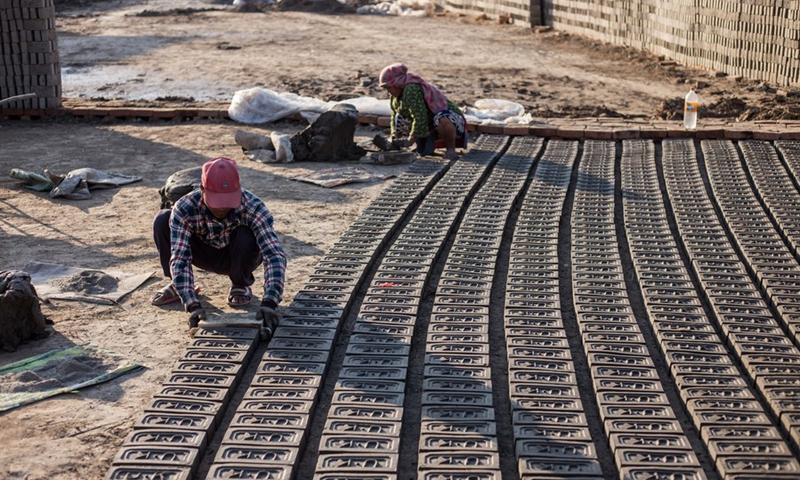Workers make bricks at a brick factory in Lalitpur, Nepal, on Jan. 4, 2022.(Photo: Xinhua)