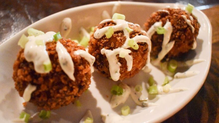 Loaded mashed potato balls with bacon, cheddar, green onions and ranch at Deep Roots Restaurant and Bar.