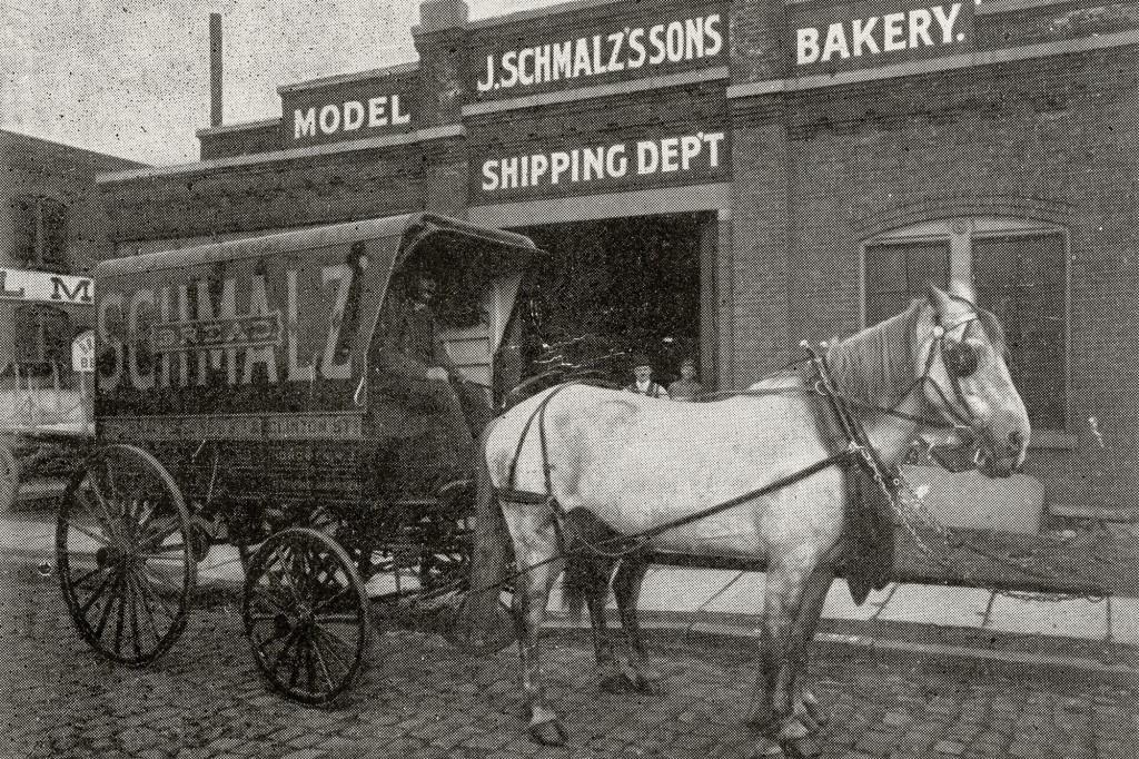 A horse carriage stands outside the Wonder Bread factory.