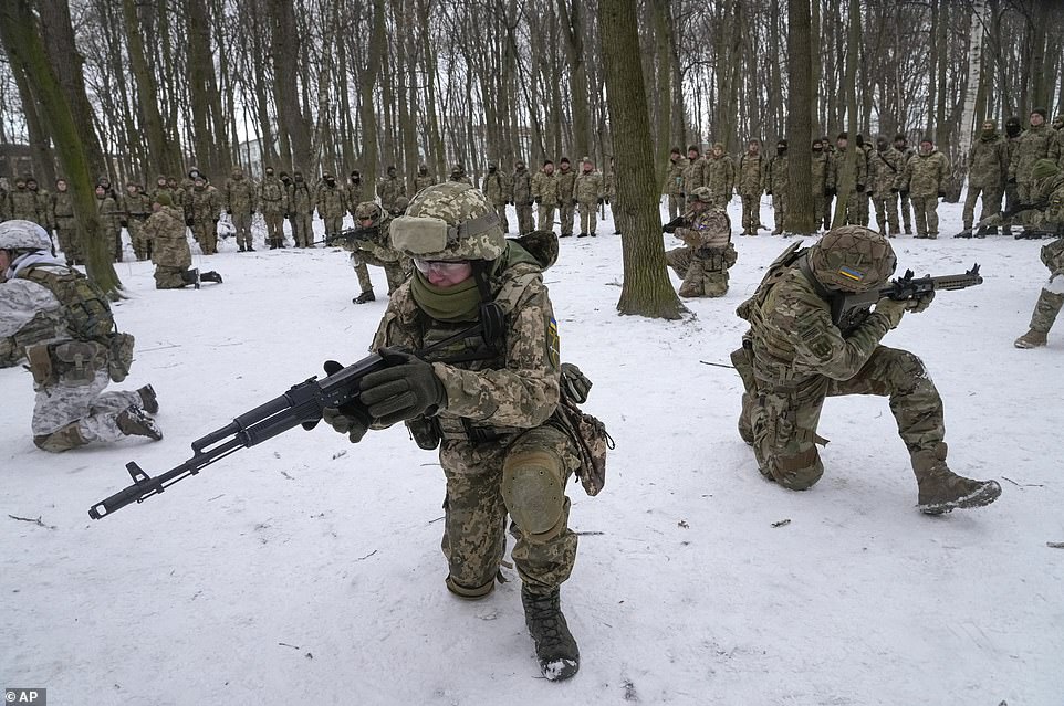 Members of Ukraine's Territorial Defense Forces, volunteer military units of the Armed Forces, train in a city park in Kyiv, Ukraine. Dozens of civilians have been joining Ukraine's army reserves in recent weeks amid fears about Russian invasion
