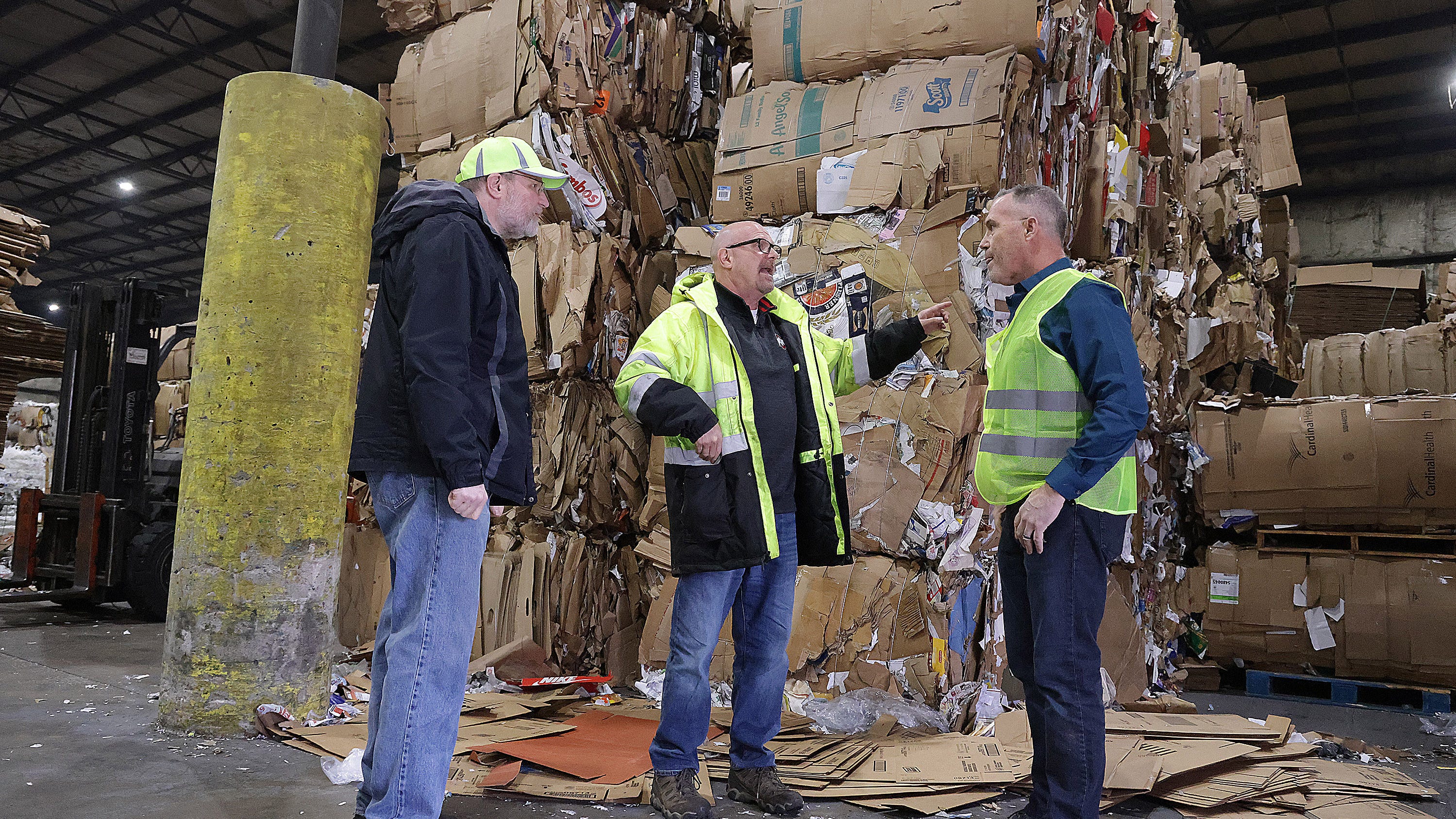 Brian and Scott Slesnick, of S. Slesnick Co., talk about cardboard with (at right) David Held, executive director Stark/Tuscarawas/ Wayne Recycling District.