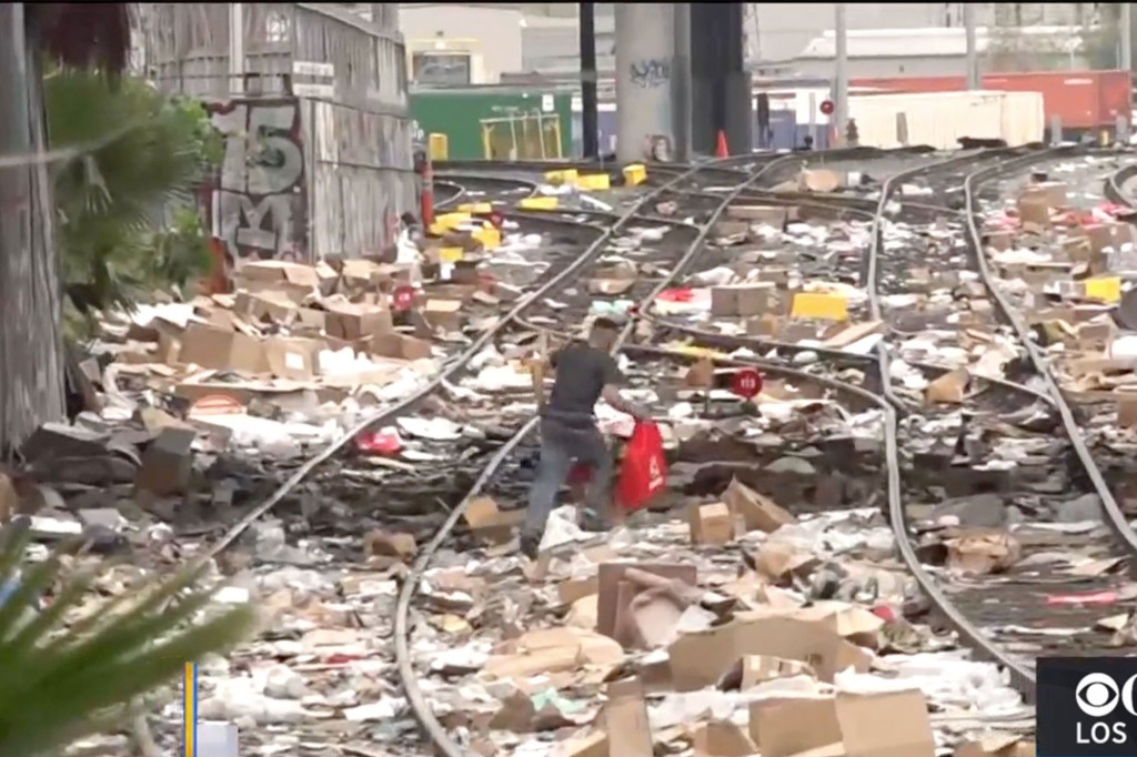 A camera crew captures a thief running away after looting a cargo container.