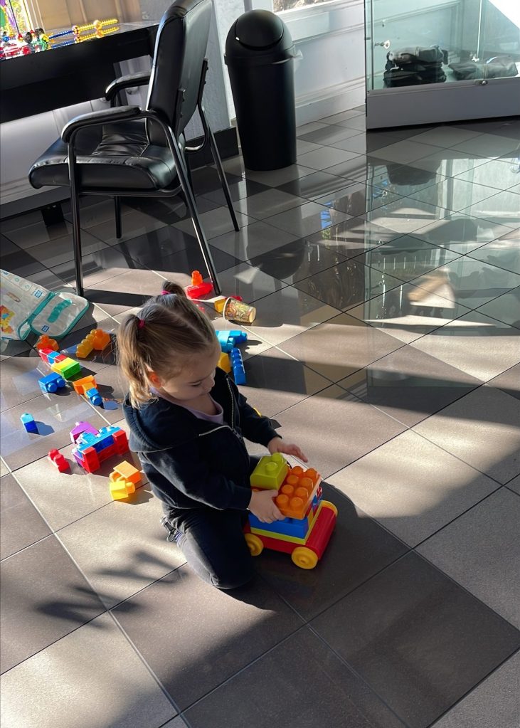 Erin Gomes plays with lego-like toys.