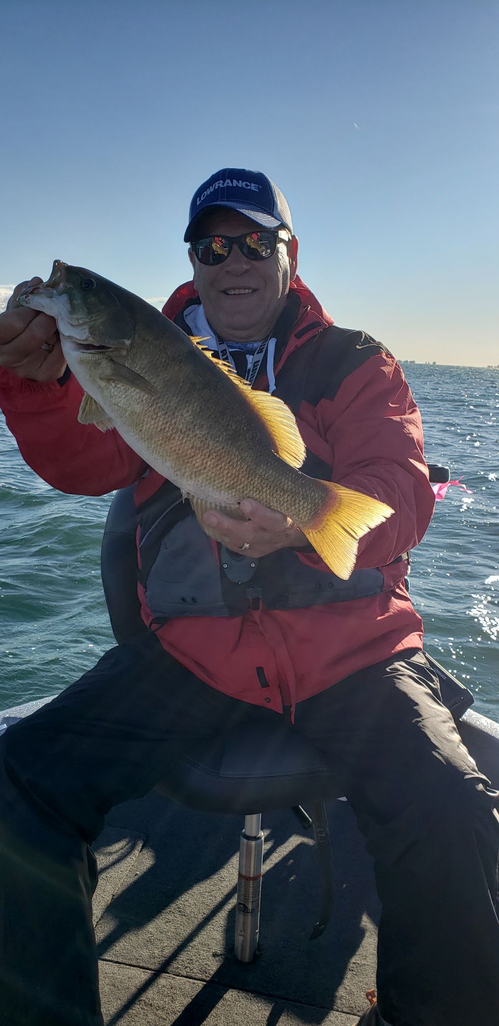 Rich Komar with a nice smallmouth bass caught while fishing a tournament on Lake St. Clair with Larry Conn; the two began friends working the Tinley Park Fishing Show. Credit: Larry Conn